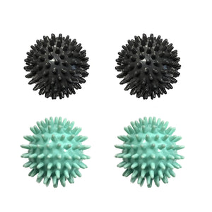 Two black and two teal massage balls with spikey knobs all over