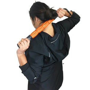 Orange massage stick with 4 rollers and a wrist strap on the end